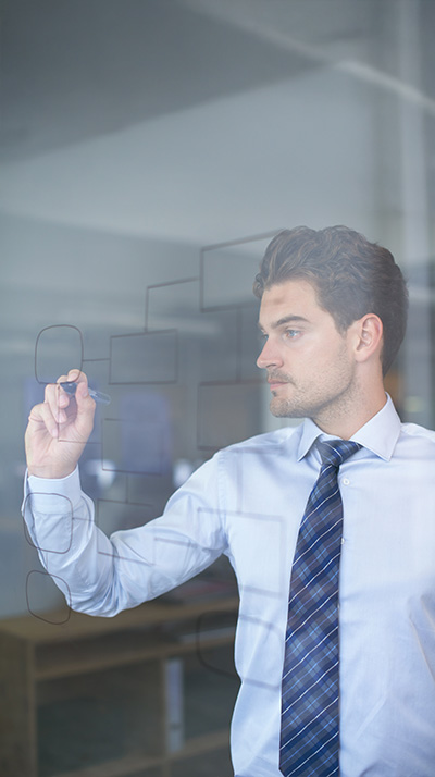 Man drawing a flowchart on a window