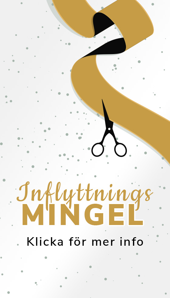 Two smiling young businessmen using laptop, standing close to a large window at an office. Light shines through.