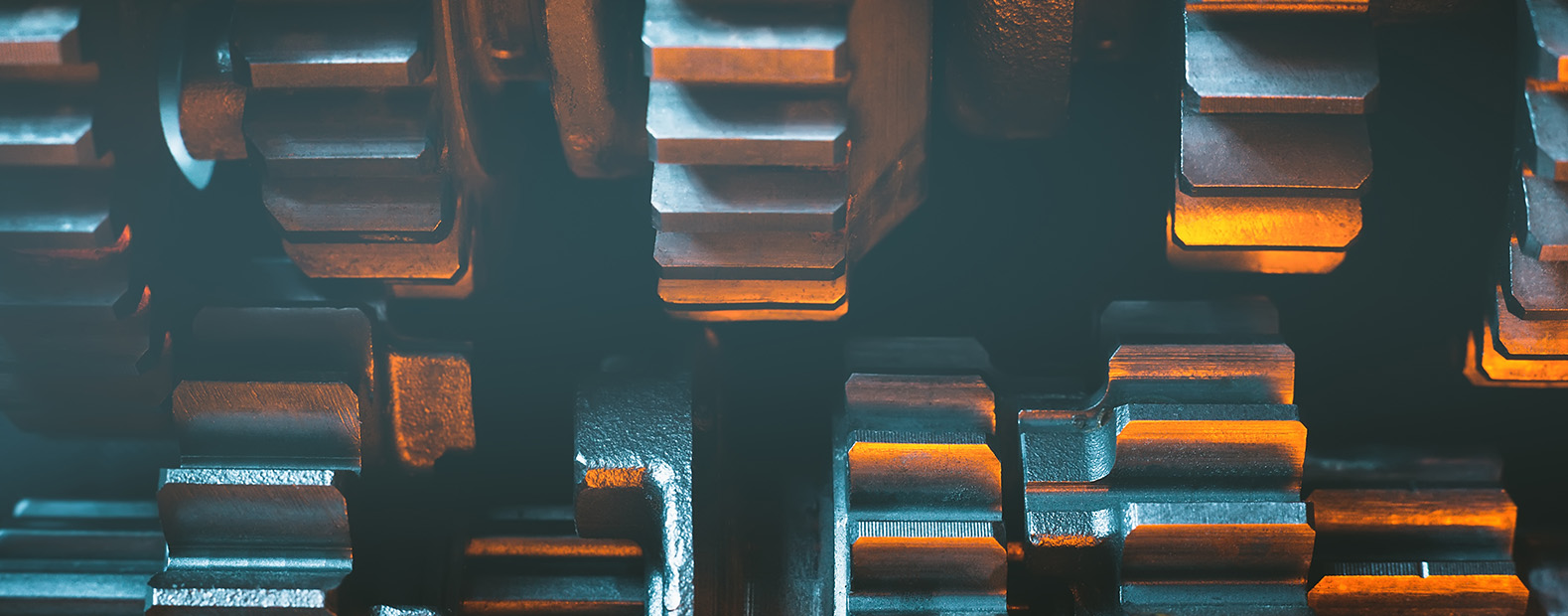 Closeup of cogwheels with orange and blue hues
